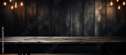 Concept for advertising Dark room with a wooden table with copyspace for text © 2rogan
