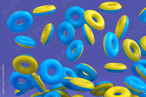 Many of flying inflatable ring for swimming pool isolated on violet background © Vasyl Onyskiv