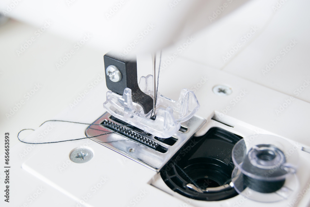 working part of a home sewing machine for handicrafts. Selective focus on plastic shuttle and sewing needle. Close-up working part of a home sewing machine for handicrafts. Selective focus on plastic shuttle and sewing needle. Close-up