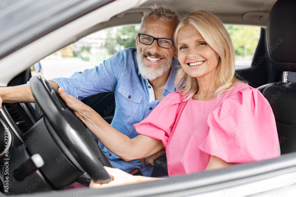 Happy senior man and woman posing together in car Happy senior man and woman posing together in car