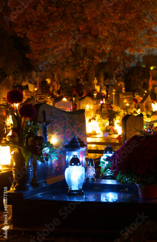 Cemetery at night with many burning candles. Catholic cemetery during All Saints' Day on November 1, celebrated in the Christian religion.