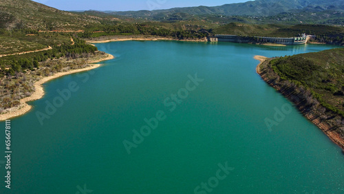 Aerial view of the reservoir with low level of water during a long drought. Forata reservoir, Valencia, Spain.