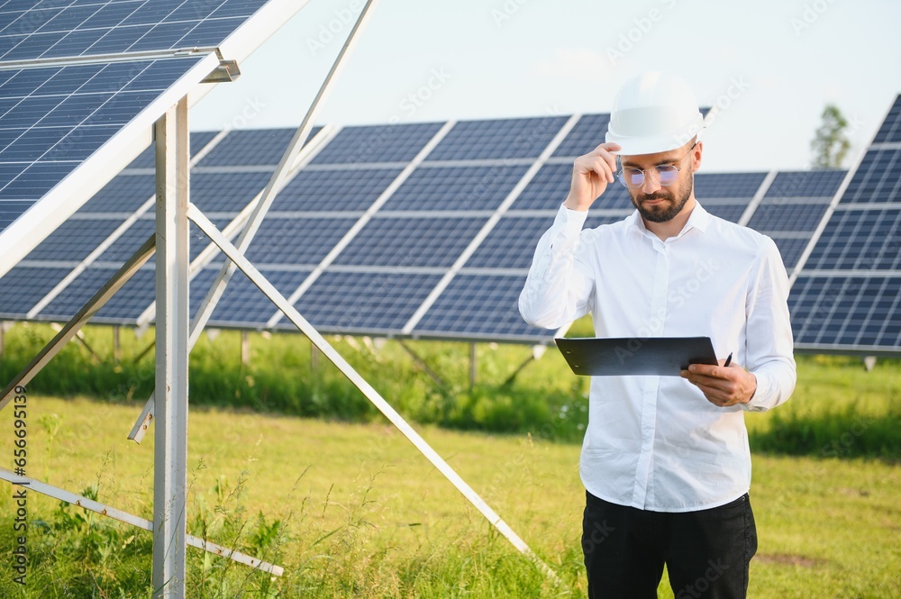 Solar power plant. Engineer on a background of photovoltaic panels. Science solar energy