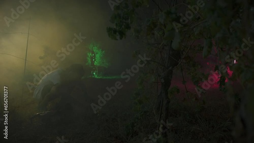 Scary Man With Chainsaw In Dark Night Misty Forest At moonlight photo