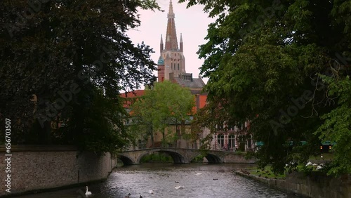 Medieval old town of Bruges in Flanders in Belgium Europe. Art and culture. Ancient gothic buildings of medieval architecture, canals with swans, cobbled alleys landscape natural foliage outdoor photo