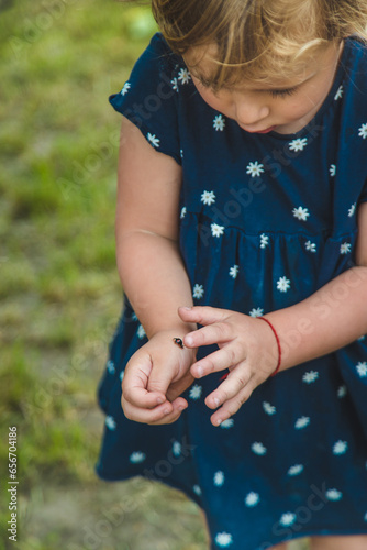 Ladybug on a child hand. Selective focus.