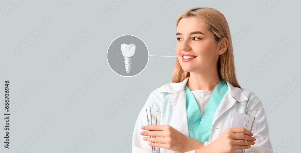 Female dentist with implanted tooth on light background Female dentist with implanted tooth on light background