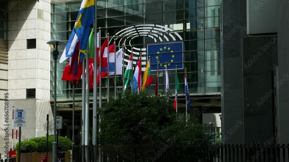 European Parliament headquarters. Peace Flags and states flags flying euro statues farmers protest tractors