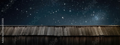 Rustic barn wood against a starry night sky background.