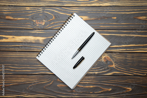 Notepad and pen on a wooden old table