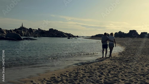 Couple strolls on the beach of Lavezzi island in Corsica, Mediterranean
