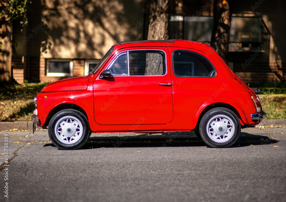 Red old Fiat 500 parked on the street. Small Italian car, side view ...