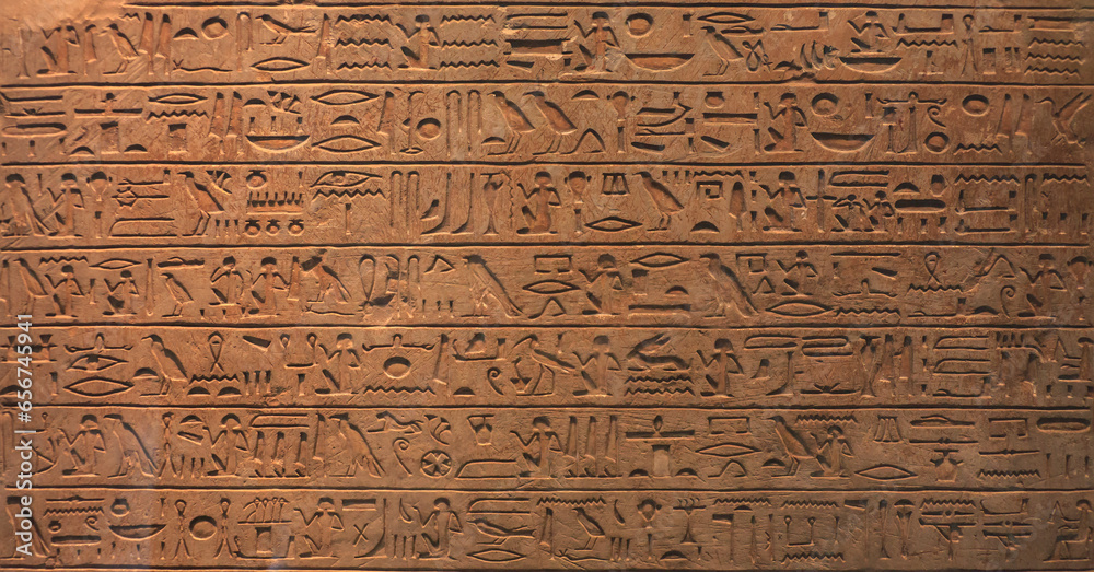 Historical Egyptian symbols, drawings and symbols in the form of text on the wall.