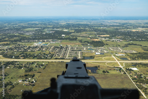 looking down machine gun in rear turret of B-24 bomber while in flight