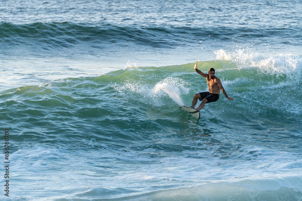 Surfer riding waves in Furadouro Beach Surfer riding waves in Furadouro Beach