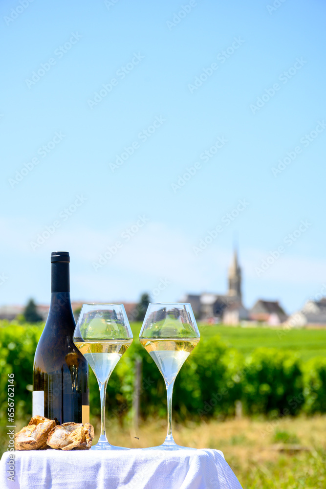 Glasses of white wine from vineyards of Pouilly-Fume appelation and example of flint pebbles soil, near Pouilly-sur-Loire, Burgundy, France