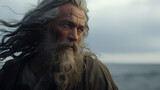 He stands proud, his long, gray hair and beard flowing in the wind. His weathered face shows the wisdom of years spent at sea.