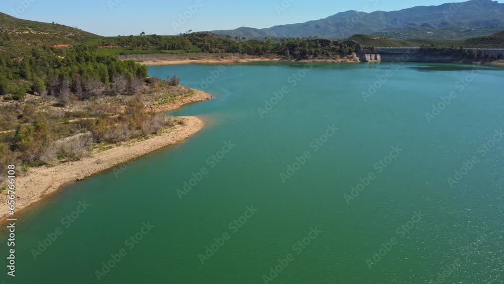 Aerial view of the reservoir with low level of water during a long drought. Forata reservoir, Valencia, Spain. Aerial view of the reservoir with low level of water during a long drought. Forata reservoir, Valencia, Spain.