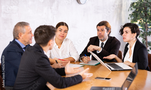 Top managers discussing in meeting room in a modern office