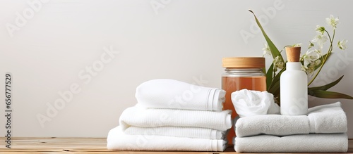 Clean towels and detergents stacked on laundry room table Text space available