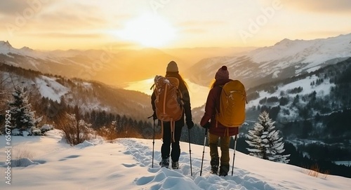 Romantic couple in winter sportswear hiking snowy mountains