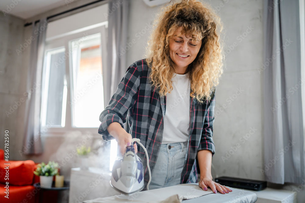 one woman ironing clothes at home hold iron household chores concept one woman ironing clothes at home hold iron household chores concept