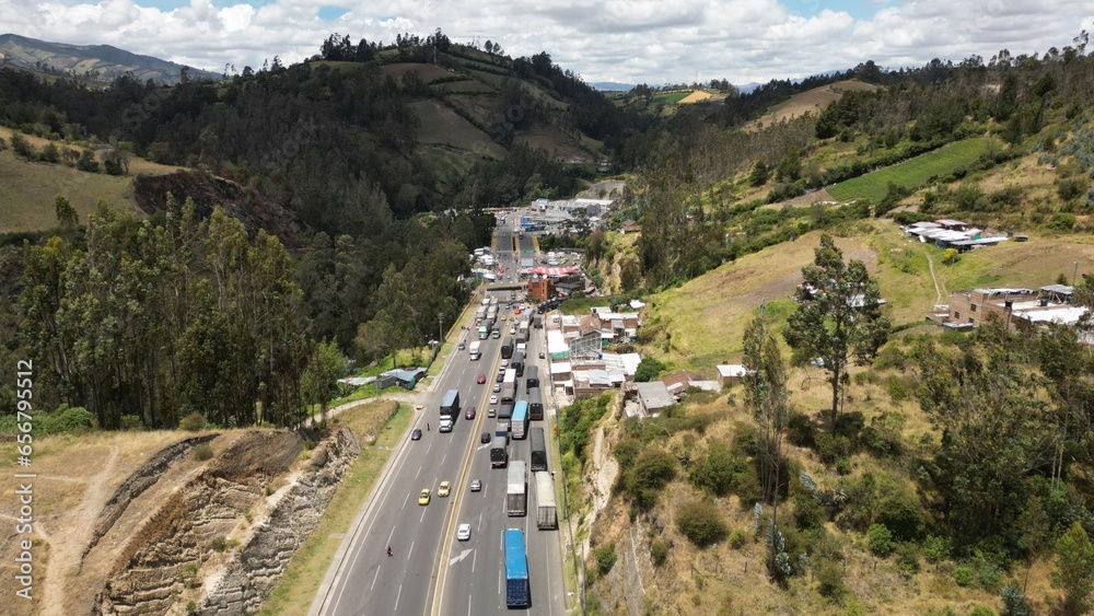 IPIALES, COLOMBIA - October 3, 2023: some cars driving through the migration checkpoint in the border line between Colombia and Ecuador, aerial shot