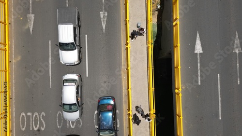 Aerial view of bridge, cars and people crossing 