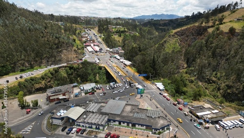IPIALES, COLOMBIA - October 3, 2023: some cars driving through the migration checkpoint in the border line between Colombia and Ecuador, aerial shot