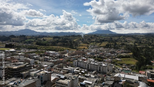 Tulcan is the capital of the province of Carchi located in Ecuador, aerial shot of the town in a sunny day. photo