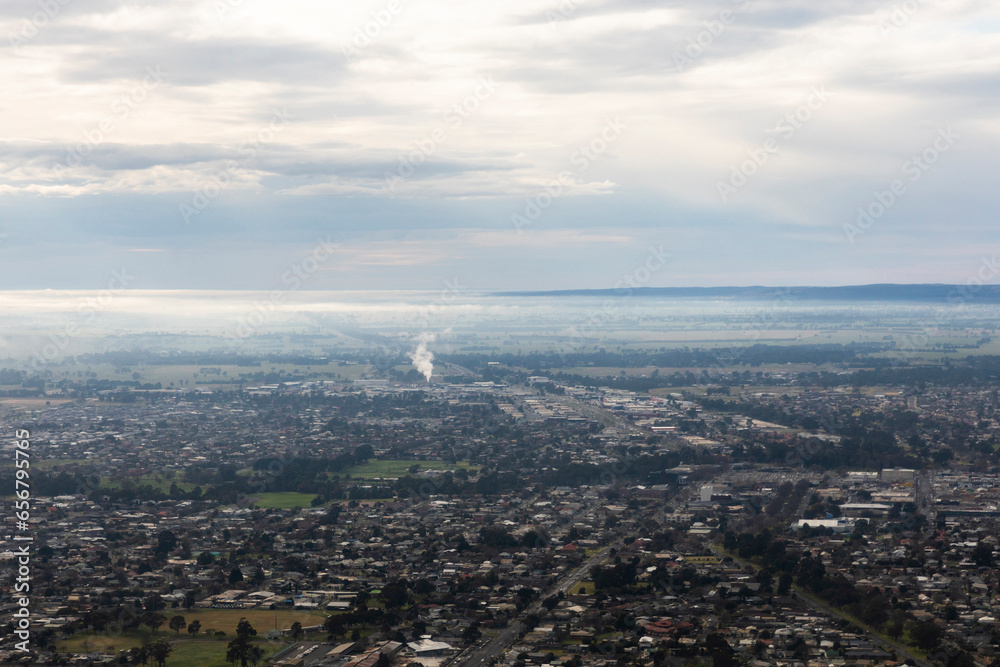Suburban Houses in Morning Mist with a Distant Smoke Plume Suburban Houses in Morning Mist with a Distant Smoke Plume