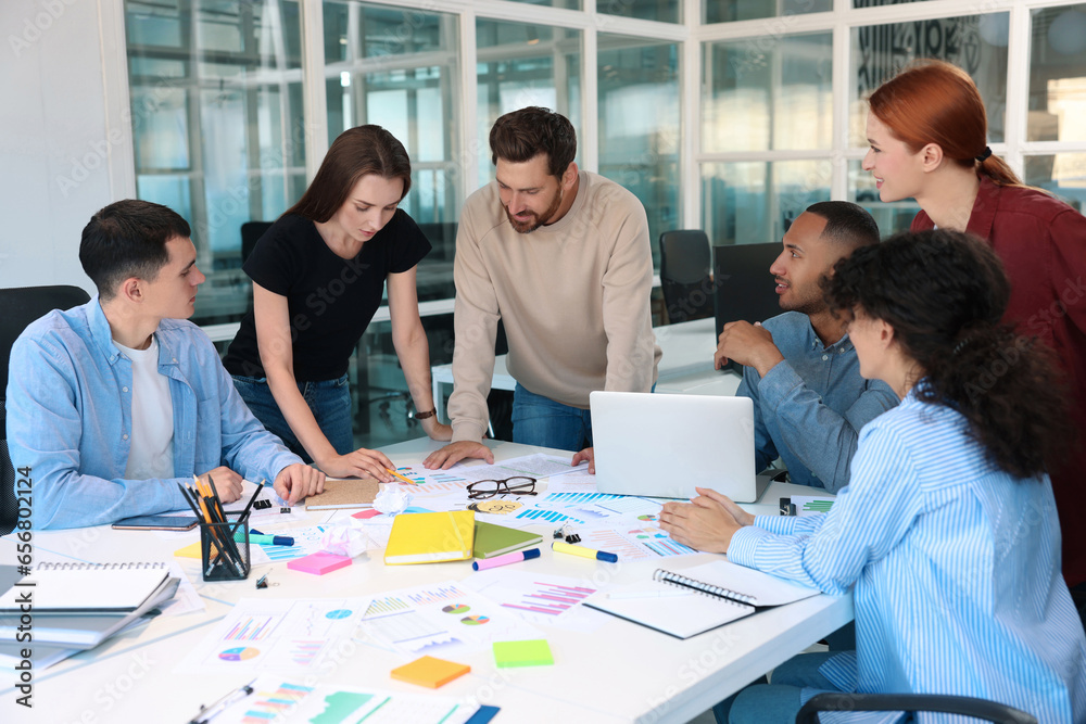 Team of employees working together at table in office. Startup project