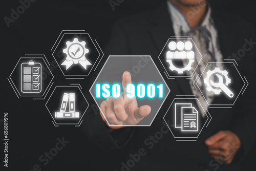 Iso 9001 concept, Business woman hand touching iso 9001 icon on virtual screen.