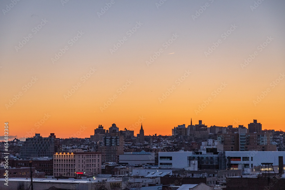 Sunrise over the skyline of Red hook New York as seen from a subway platform in Gowanus at golden hour. 