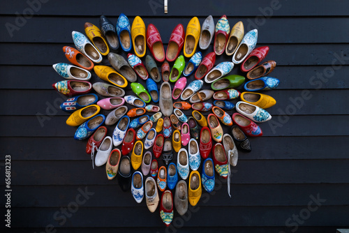Netherlands, Zandam. Heart-shaped wooden sabots adorn the front of a building. Sabots, colourful shoes. Tourist attraction, folk folklore.  photo