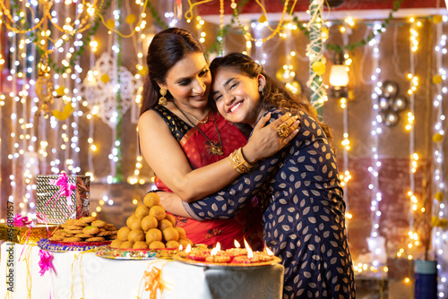 Woman hugging her daughter on Diwali festival