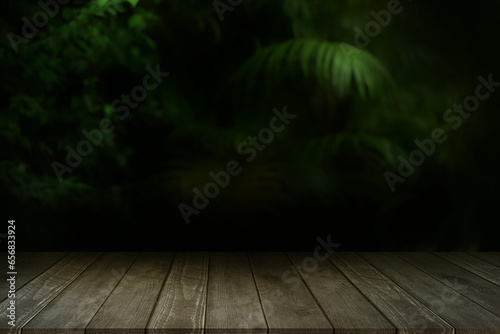 Empty wooden table in front of abstract blurred background of forest mysterious natural.
