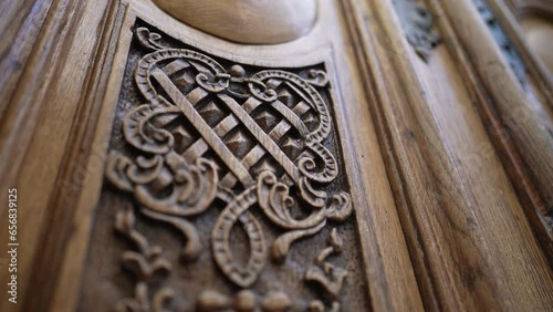 Beautiful elegant adornment ornamentation engraved on wooden ancient door, traditional antique building architecture