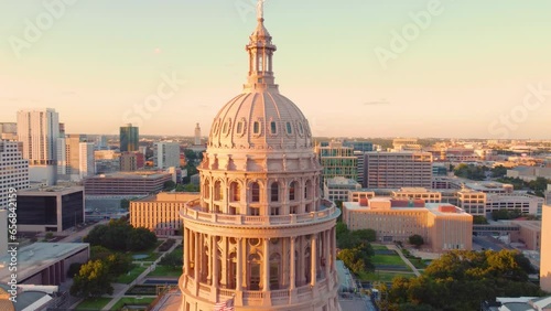 Downtown Austin, Texas State Capital Building, Aerial Drone Shot Flying over Goddess of Liberty Statue on Top with Views of The University of Texas at Austin Campus Skyline at Sunset in 4K. photo