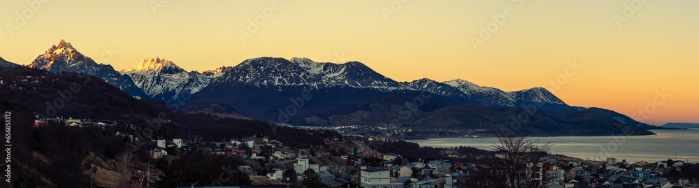 Panoramic sunrise of the mountain range and city of Ushuaia in the Beagle Channel