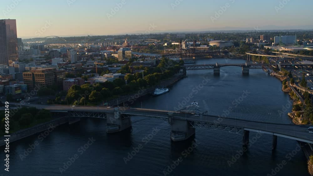 Epic high shot over city, bridge and river near sundown - drone shot Epic high shot over city, bridge and river near sundown - drone shot