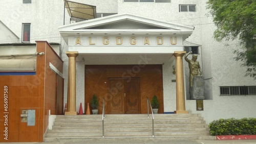 A Masonic temple or lodge. Two golden pillars on each side. On the top the acronym of ALGDGADU which is abbreviation in Spanish for Glory to the grand architect of the universe. Located in Lima, Peru. photo