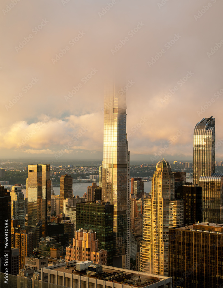 Epic sunset after the rain. Amazing aerial cityscape landscape about New York city, Manhattan. Famous skyscrapers on the photo. Cloud covered high lines.