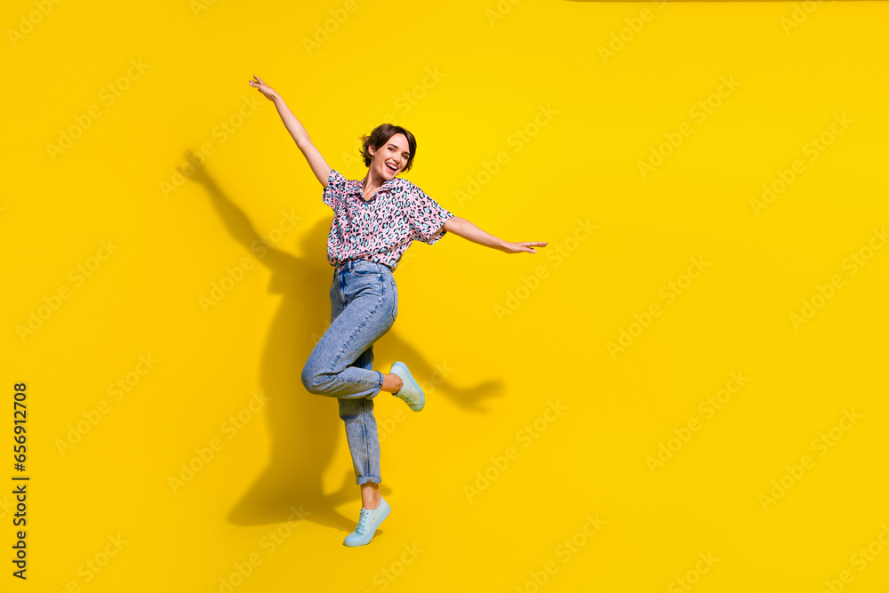 Full body portrait of lovely overjoyed lady raise arms have good mood dancing partying empty space isolated on yellow color background