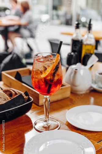 Glass with Aperol-spritz cocktail.