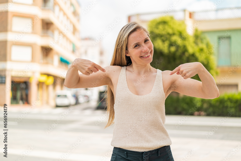 Young blonde woman at outdoors proud and self-satisfied Young blonde woman at outdoors proud and self-satisfied