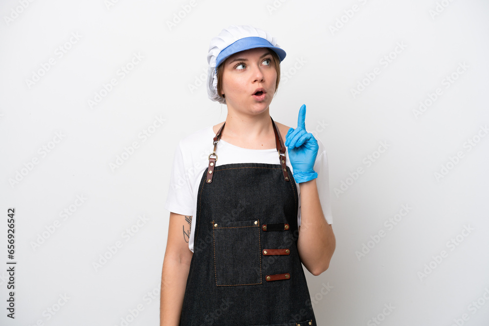 Fishmonger woman wearing an apron thinking an idea pointing the finger up Fishmonger woman wearing an apron thinking an idea pointing the finger up