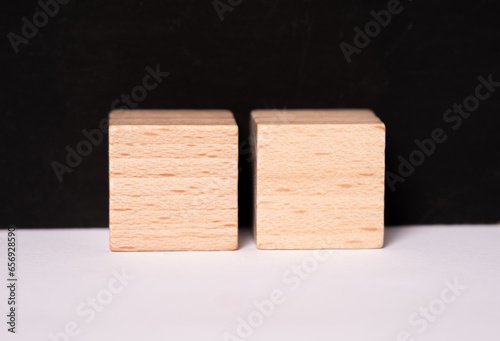 Two empty wooden cubes with place for letters