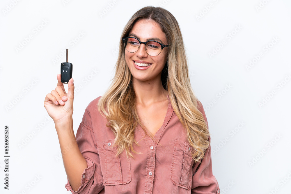 Young pretty Uruguayan woman holding car keys isolated on white background with happy expression Young pretty Uruguayan woman holding car keys isolated on white background with happy expression