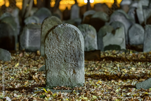 Tombstones in an old cemetery at night.